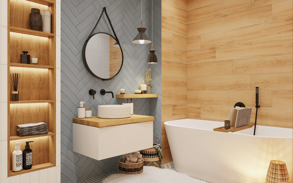 SIKO Moderná kúpeľňa s vaňou, drevenými policami, okrúhlym zrkadlom a sivými a drevenými obkladmi.