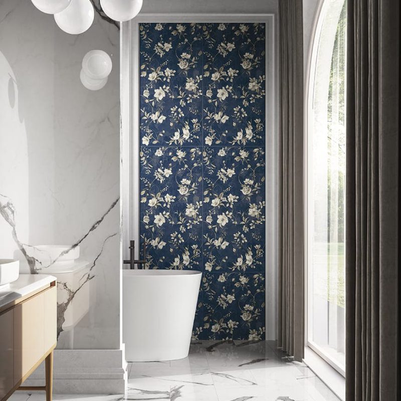SIKO Výrazné květinové vzory na tmavěmodrém podkladu v koupelně s volně stojící vanou.