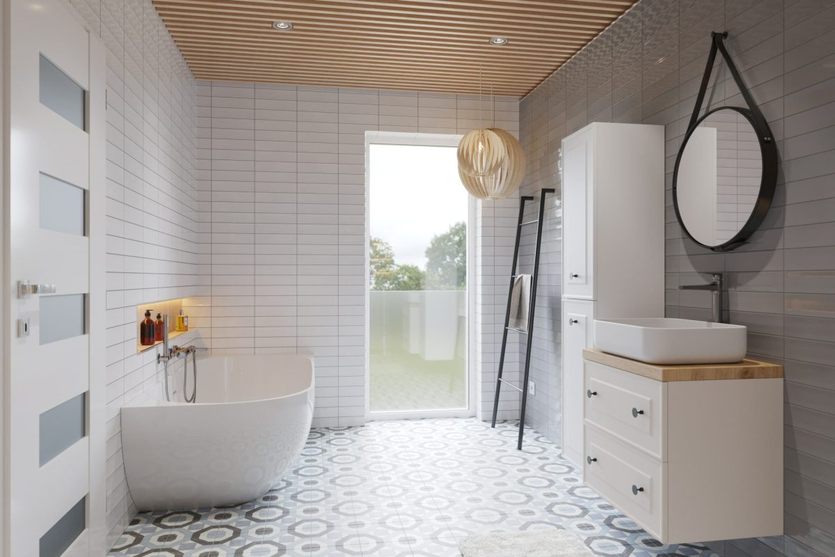 SIKO_Hygge a skandinávský styl v koupelně s velkým oknem do zahrady, volně stojící vana, stylové doplňky, kulaté zrcadlo na řemenu, patchwork dlažba