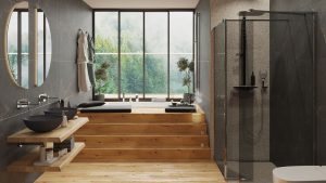 SIKO_COVER_Stylové řešení wellness koupelna, prostorný sprchový kout s kouřovými skly, zapuštěná vana, velké okno, kulaté zrcadlo, dřevěná dlažba, šedý obklad